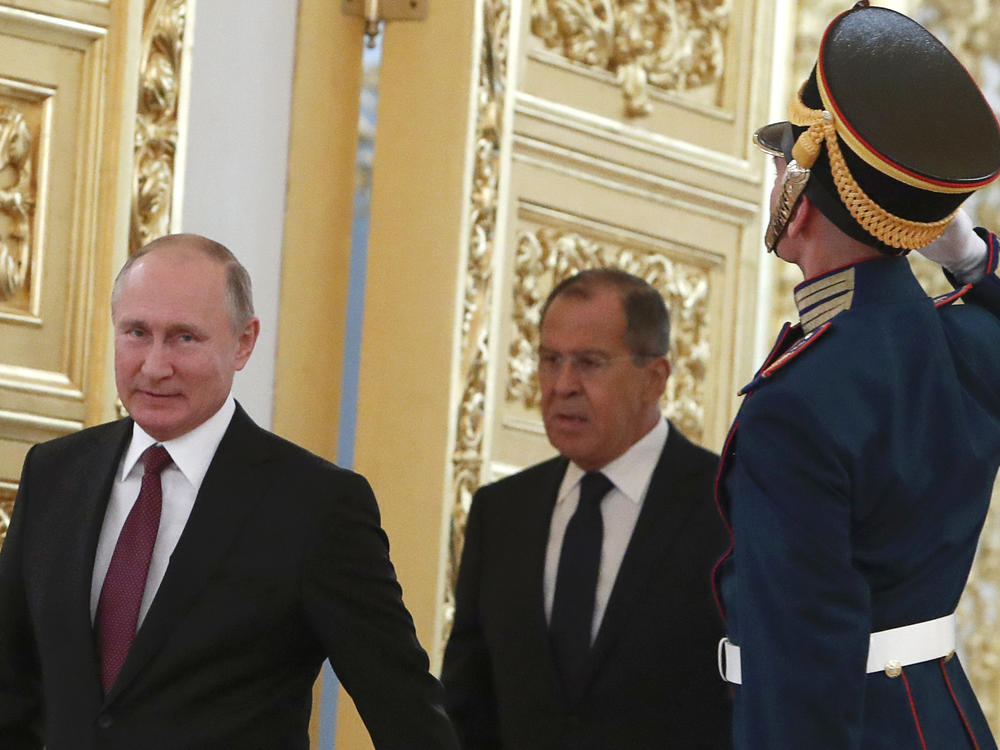 Russian President Vladimir Putin and Foreign Minister Sergei Lavrov walk past honour guards at the Kremlin in Moscow. U.S. sanctions are targeting Putin and a handful of individuals believed to be among his closest advisors.