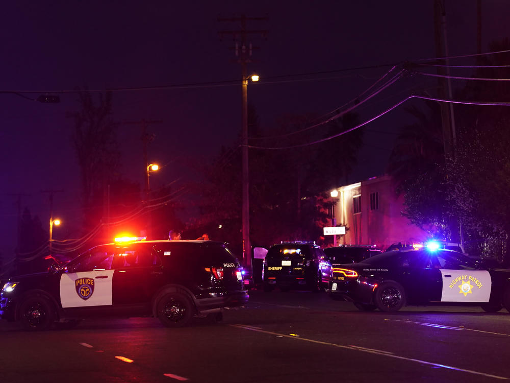 Law enforcement vehicles from several agencies block a street near the scene of a shooting in Sacramento, Calif., on Monday.
