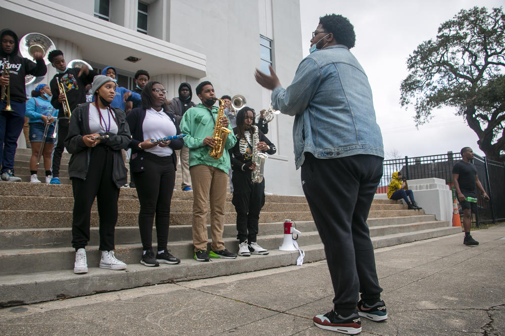 Frederick A. Douglass High School band director Jordan Harper conducts. At the beginning of this school year, the band didn't have any members; now, there's 50.