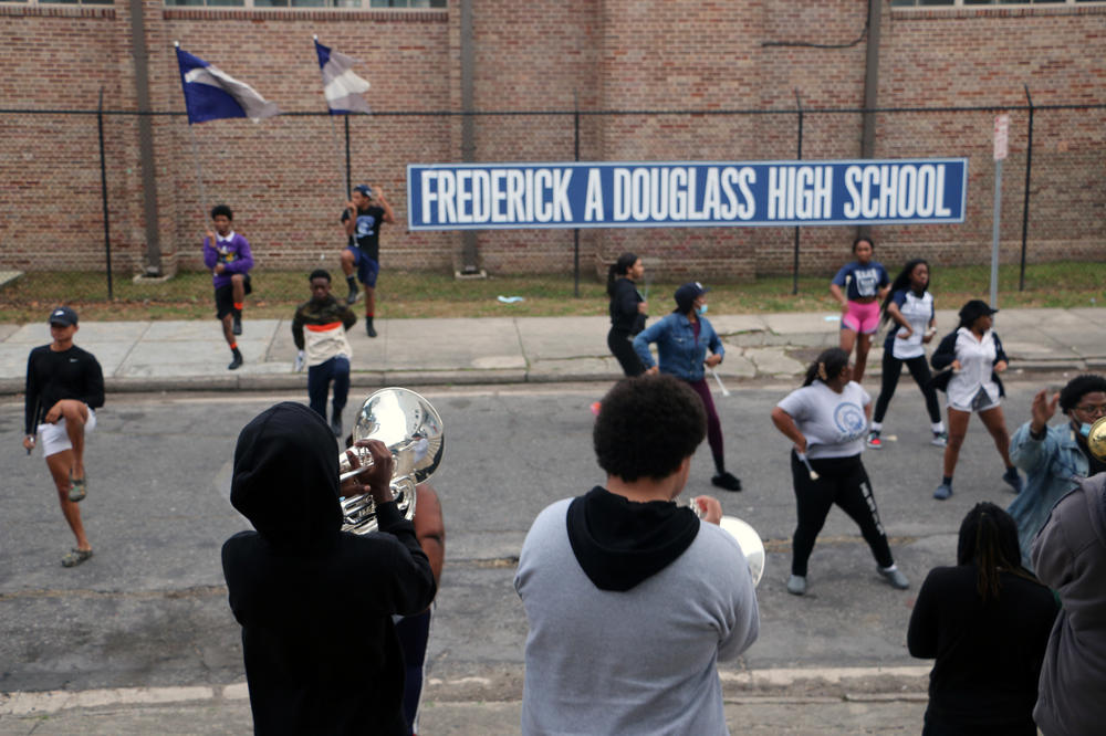 The band at Frederick A. Douglass High School practices outside of the school. The band had no members when director Jordan Harper took it over at the start of the school year.