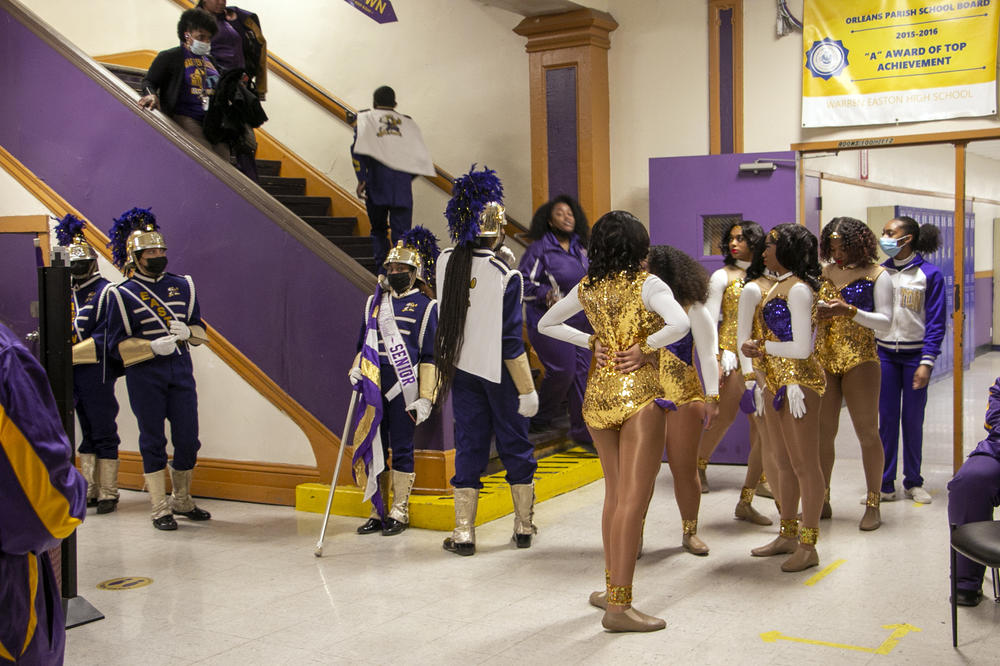 Warren Easton's color guard, majorettes and flag twirlers get ready to head to the school's first parade of the year.