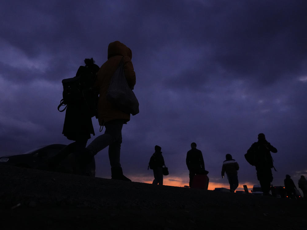 Refugees fleeing the fighting in neighboring Ukraine arrive at Przemysl, Poland on Saturday.