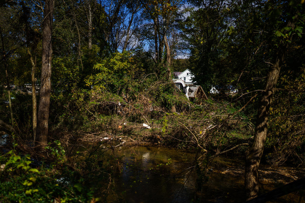 Debris displaced by floodwaters remains on the banks of Trace Creek, more than two months after floods tore through Waverly, Tenn.