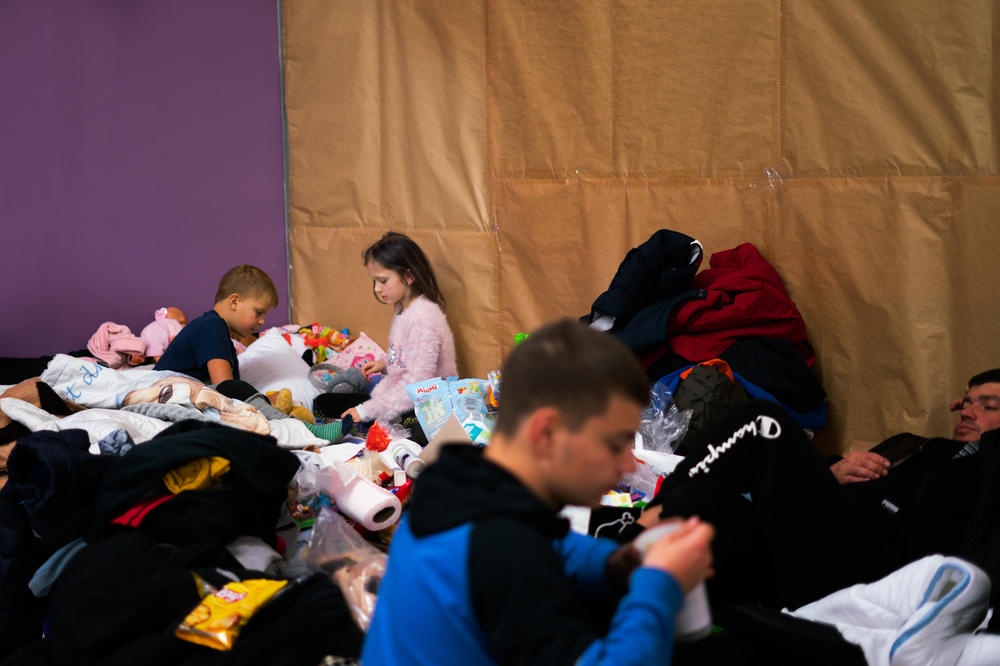 Karpenko's children play with other kids in the temporary shelter after crossing the border into Poland by bus.