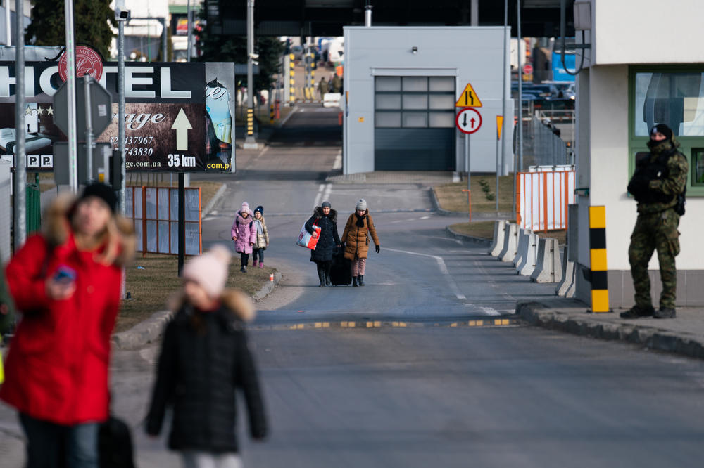 People walk into Poland from Ukraine at the Medyka border crossing.