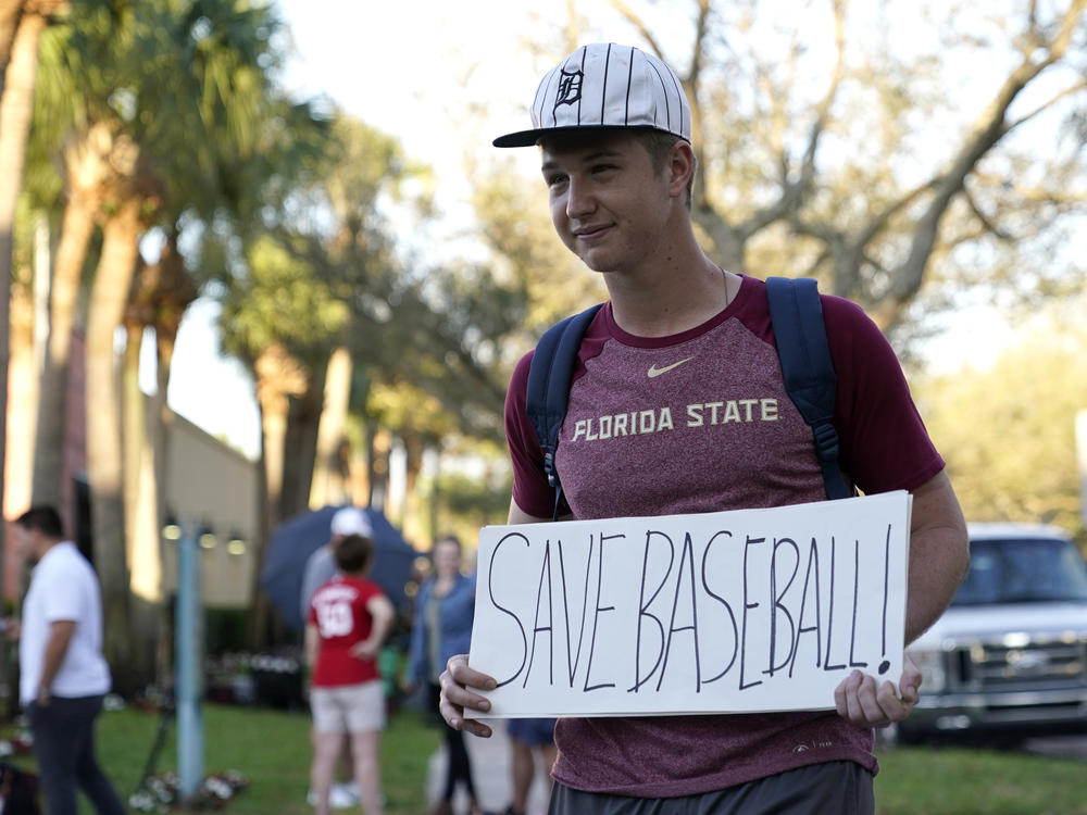 A baseball fan stands outside Roger Dean Stadium as Major League Baseball negotiations continued earlier this week in Jupiter, Fla.