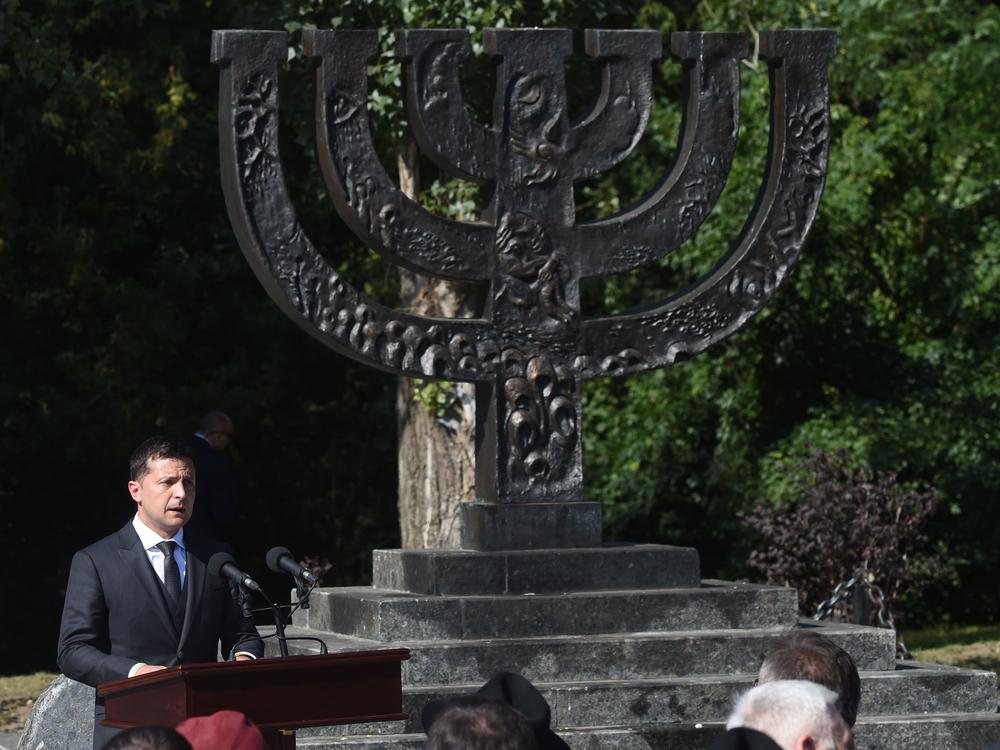 Ukrainian President Volodymyr Zelenskyy delivers a speech next to a menorah at The Babyn Yar Holocaust Memorial Center in Kyiv on Aug. 19, 2019.