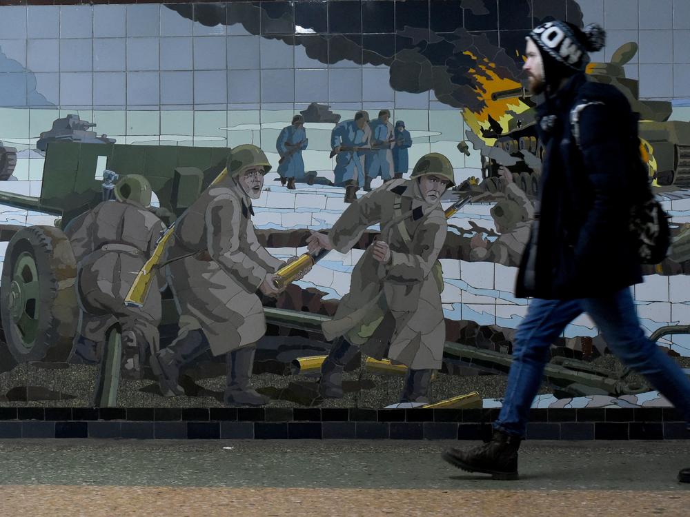 A man walks past a mosaic depicting a World War II battle scene in Rostov-on-Don, a Russian city bordering Ukraine.