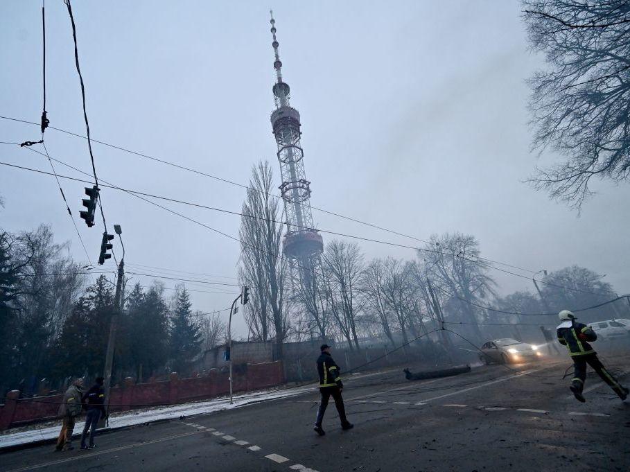 A fireman runs Tuesday after Russian airstrike hit Kyiv's main television tower in Kyiv in the heart of the Ukrainian capital.