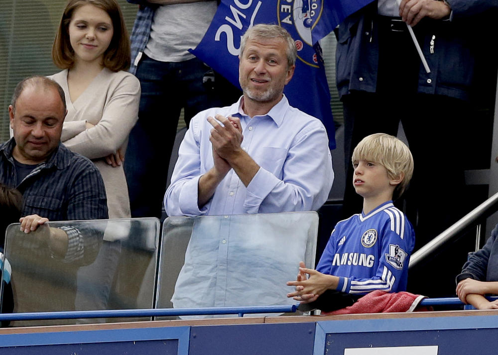 The Chelsea Football Club's owner, Roman Abramovich (center), applauds after Chelsea was presented with the Premier League trophy after its match against Sunderland at Stamford Bridge stadium in London on May 24, 2015.
