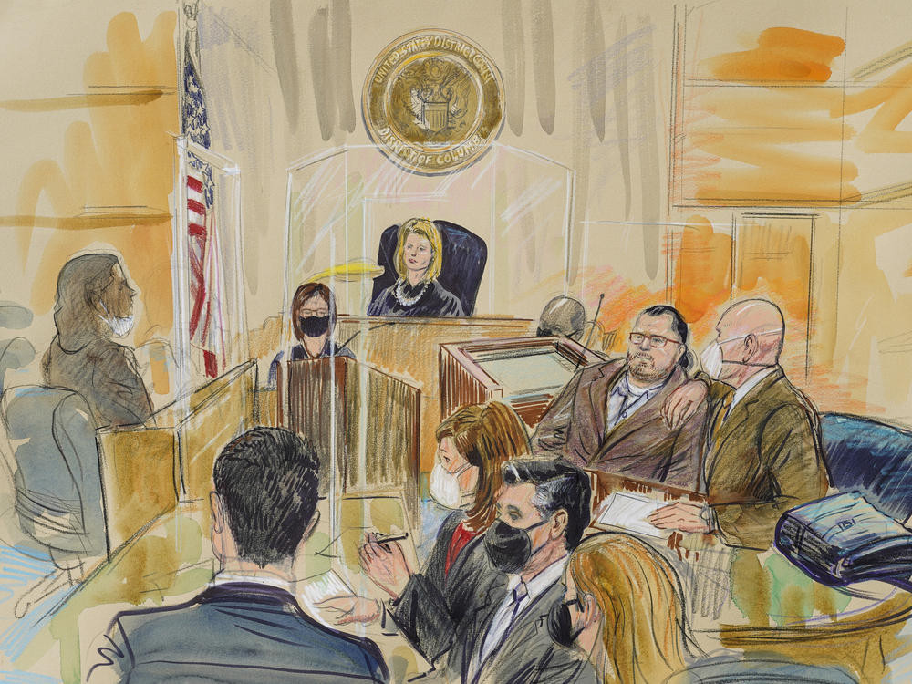 This artist sketch depicts Judge Dabney Friedrich looking out from the bench during proceedings in the trial against Guy Wesley Reffitt, joined by his lawyer William Welch, top right, in federal court in Washington.