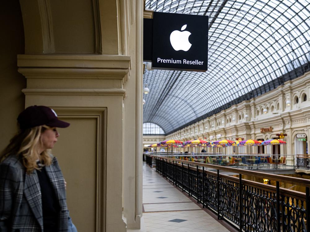 A woman passes by an Apple store at the GUM department store in central Moscow on April 27, 2021. Apple said this week that it's pausing the sale of its products in Russia.