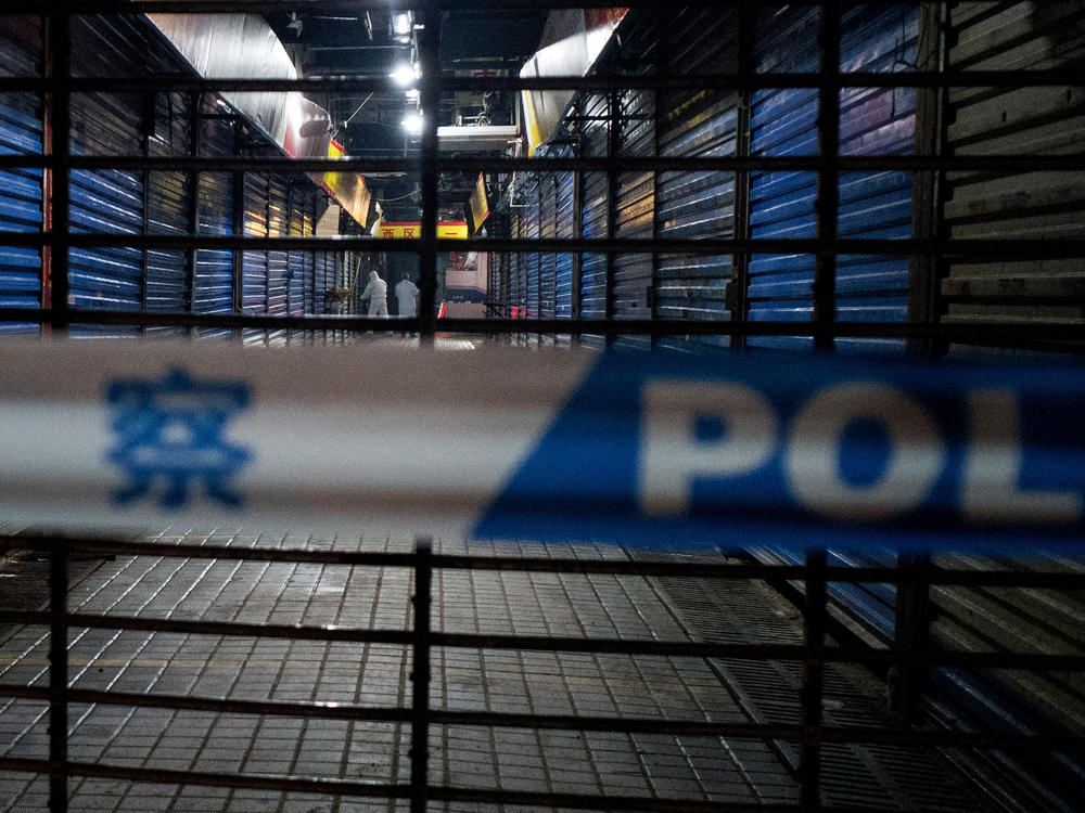 Staff members of the Wuhan Hygiene Emergency Response Team investigate the shuttered Huanan Seafood Wholesale Market on Jan. 11, 2020, after it was linked to cases of COVID-19.