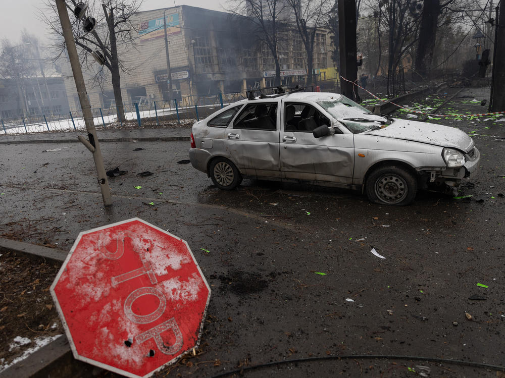 Rubble and a damaged vehicle is seen across the street from the Kyiv TV Tower on Wednesday.