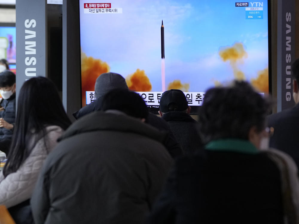 People watch a TV showing a file image of North Korea's missile launch during a news program at the Seoul Railway Station in Seoul, South Korea, on Saturday, March 5, 2022. North Korea on Saturday fired a suspected ballistic missile into the sea, apparently extending its streak of weapons tests this year amid a prolonged freeze in nuclear negotiations with the United States.