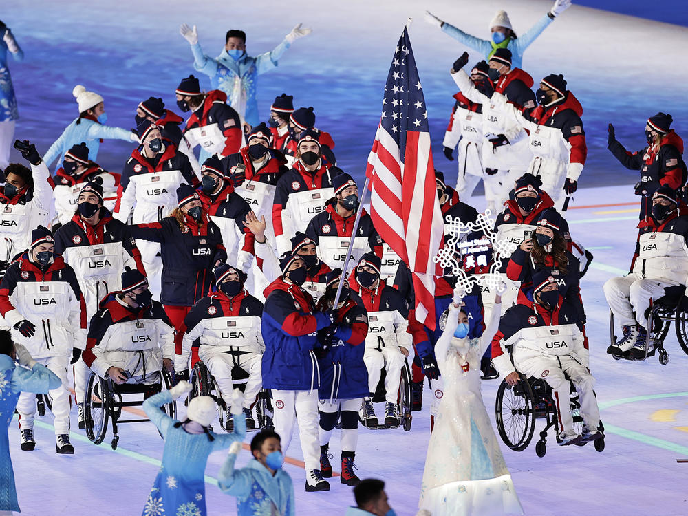 Flag bearers Tyler Carter and Danelle Umstead lead Team USA during the opening ceremony of the Beijing 2022 Winter Paralympics on Friday.