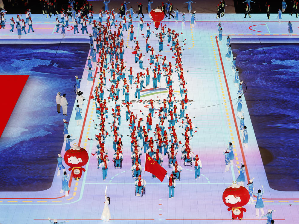 Flag bearers Yujie Guo and Zhidong Wang of Team China lead their team out during the Opening Ceremony of the Beijing 2022 Winter Paralympics.