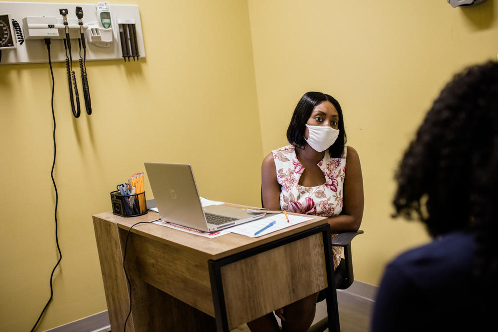 Margarette Osias, patient navigator for the Delaware Breast Cancer Coalition, helps a patient schedule a cancer screening. Osias is a bilingual Haitian Creole speaker, which helps her connect with the community she works with in Sussex County, Del.