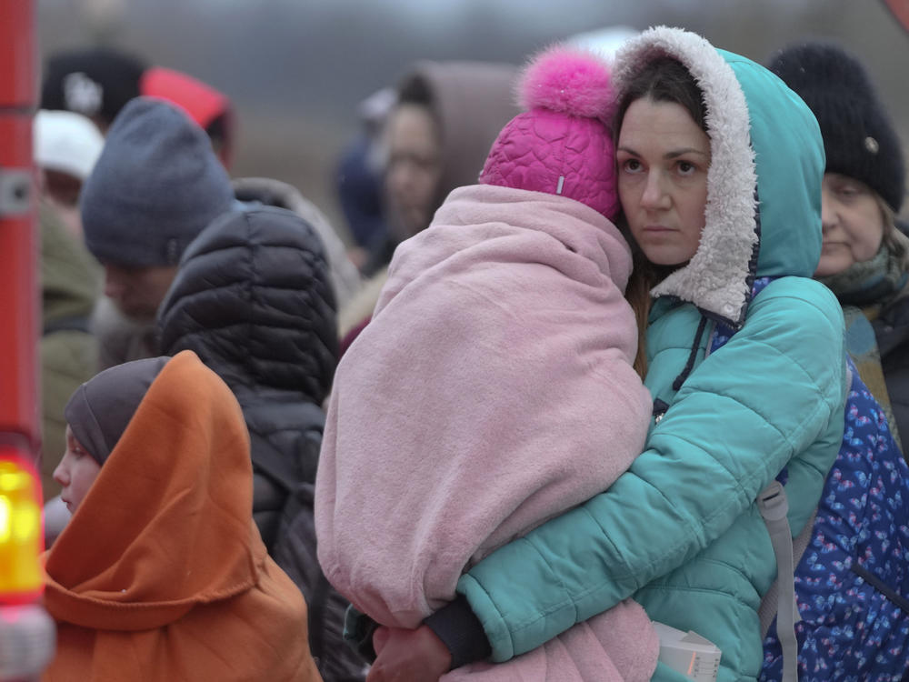 Refugees, mostly women with children, wait for transportation at the border crossing in Medyka, Poland, on Saturday after fleeing from Ukraine.