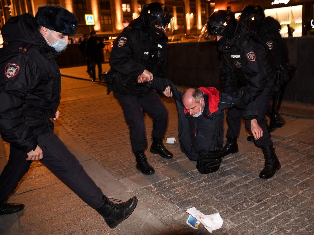 Police officers detain a man during a protest in Moscow Thursday against Russia's invasion of Ukraine.