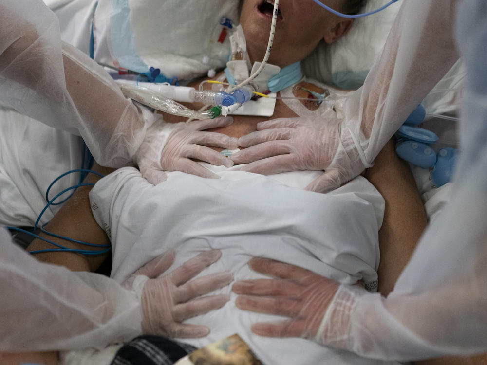 Nurses perform timed breathing exercises on a COVID-19 patient on a ventilator in the COVID-19 intensive care unit at the la Timone hospital in Marseille, southern France on Dec. 31, 2021.