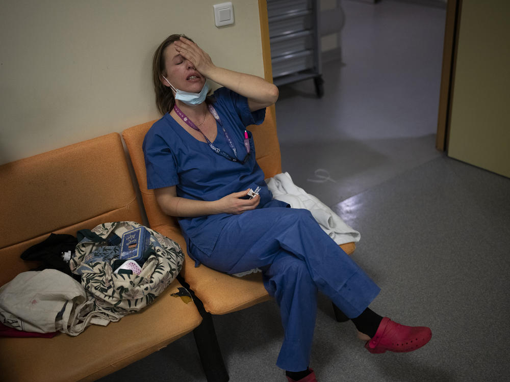 Nurse Marie-Laure Satta pauses during her New Year's Eve shift in the COVID-19 intensive care unit at the la Timone hospital in Marseille, southern France, on Dec. 31, 2021.