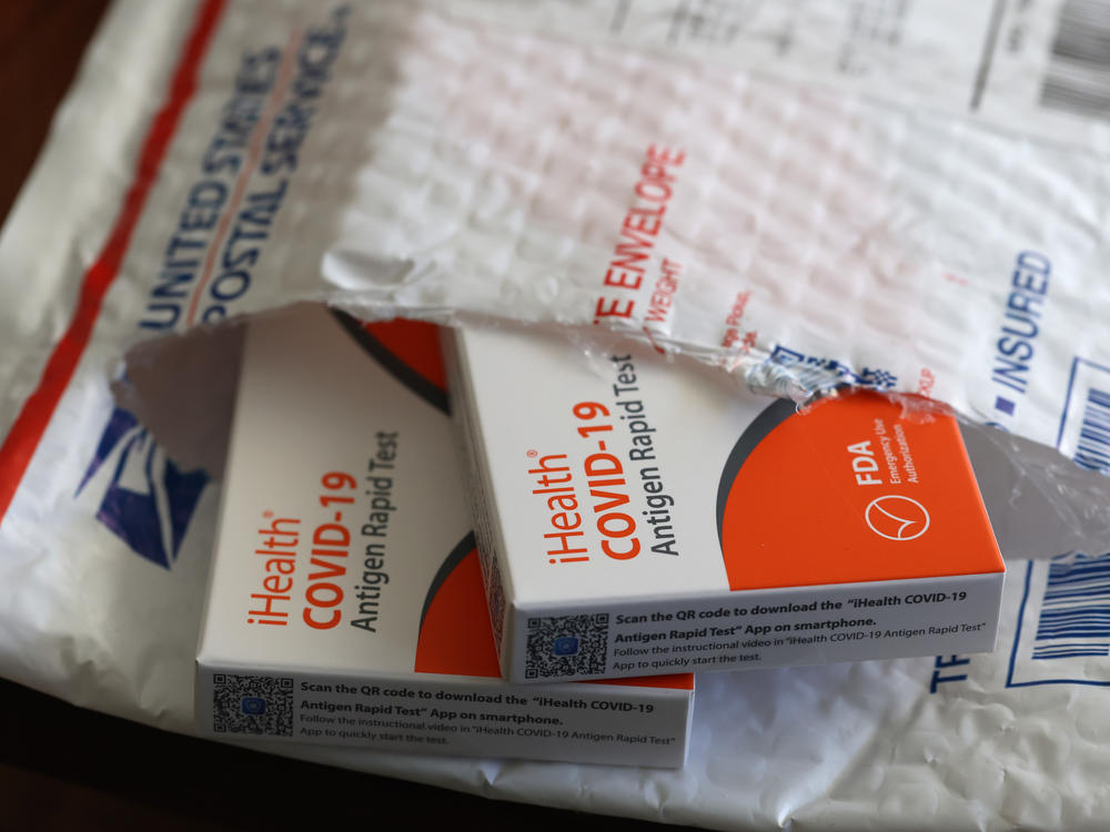 In this photo illustration, free iHealth coronavirus rapid tests from the federal government sit in a U.S. Postal Service envelope after being delivered on Feb. 4.