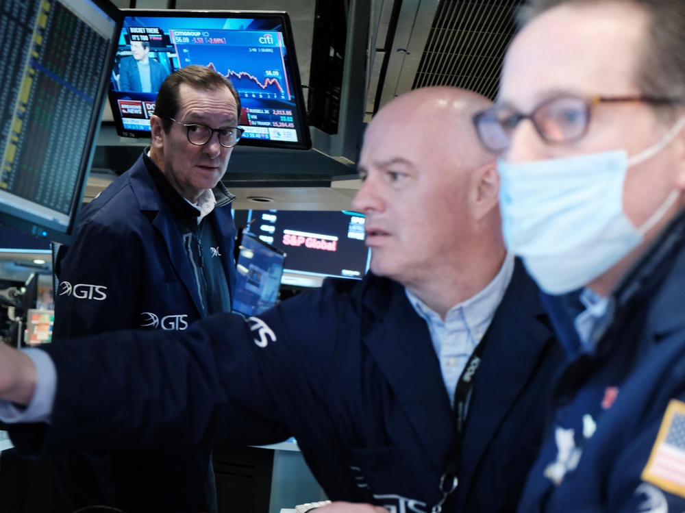 Traders work on the floor of the New York Stock Exchange in New York City on March 4. The Dow Jones Industrial Average slumped nearly 800 points on Monday, entering what's called a correction.