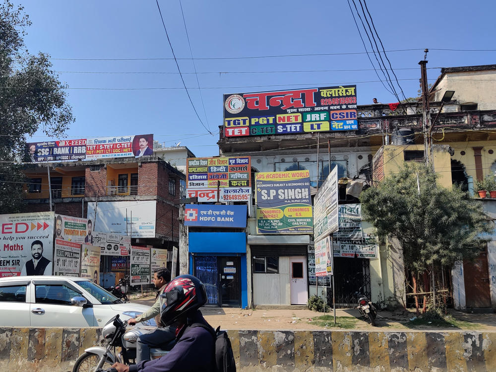 Signs in Prayagraj advertise companies that promise to prep young people for exams for government jobs.