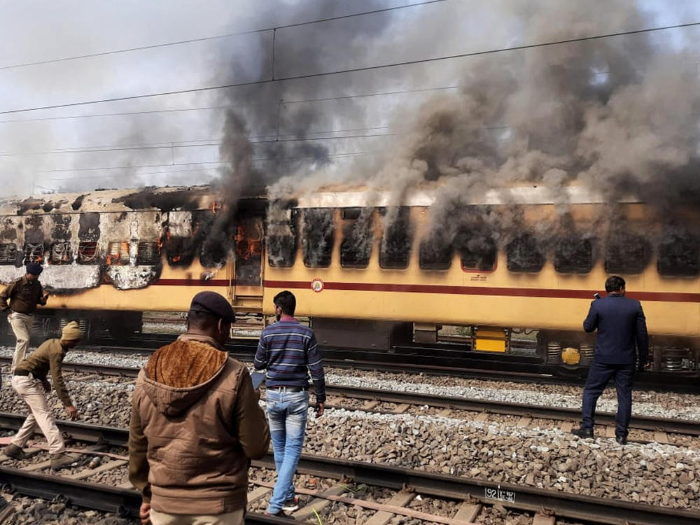 A mob set this train car afire as they protested railway jobs that set increasingly demanding requirements, shutting out many applicants. What the media called a 