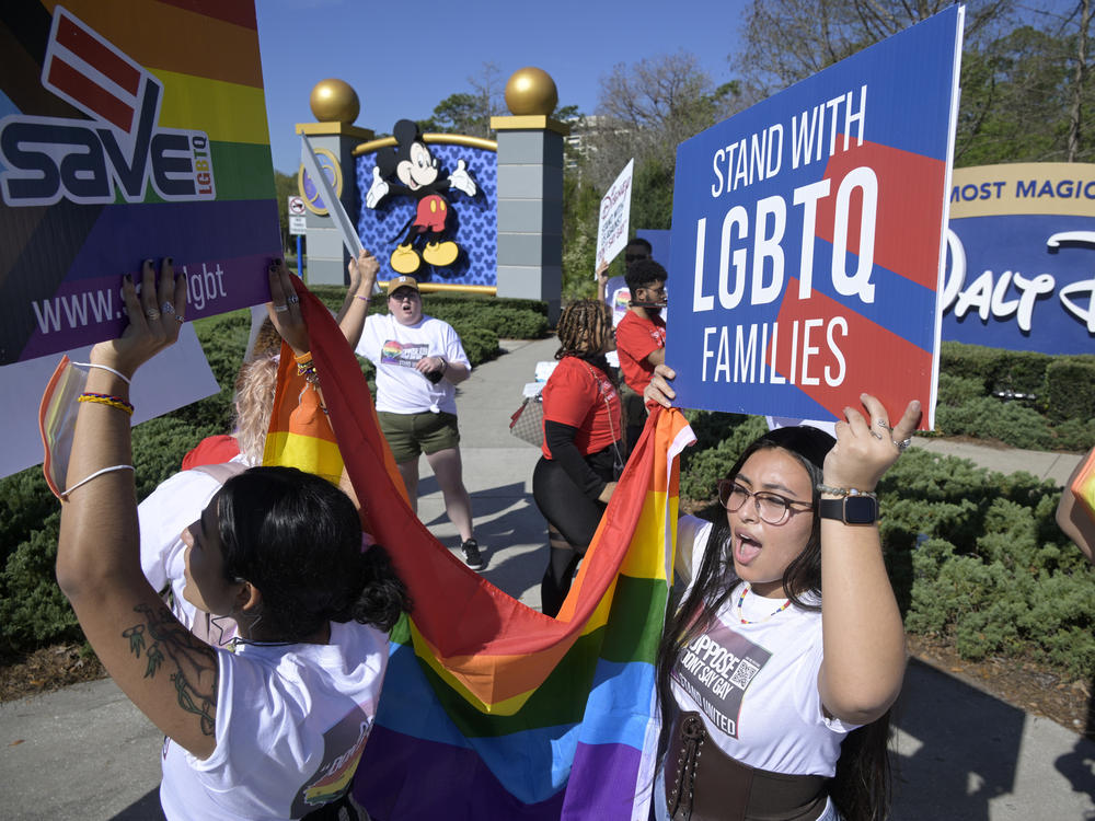 LGBTQ advocates march at a rally at Walt Disney World in Orlando, Fla., to urge the company to publicly oppose what they call the 