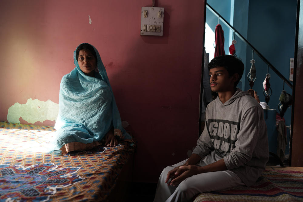 <em>Shanti Devi's husband died of COVID in May 2021. Her usual resting spot in her modest home is on the bed by a window. </em><em>Her 17-year-old son, Yash Arya, is trying to balance his own dreams with his family's needs after his father's death.</em>