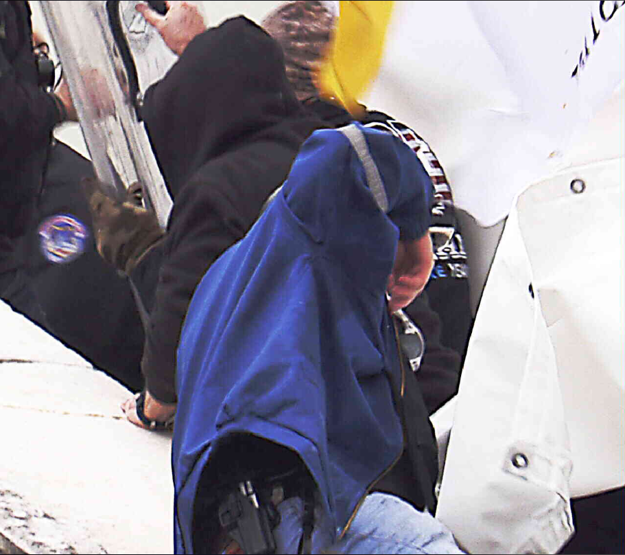 Reffitt's defense team denied that he had a gun with him on Jan. 6, but prosecutors showed an image of Reffitt, as seen here, on the steps of the U.S. Capitol with a holster holding a shiny object that they alleged was a handgun.