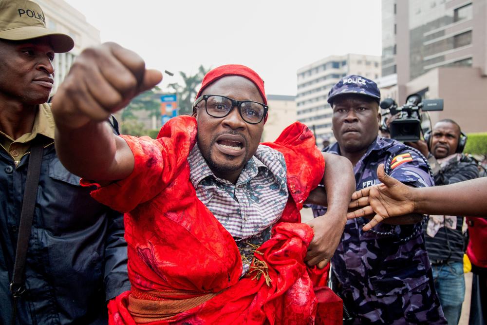 A protester is arrested by police during a demonstration on July 11, 2018 in Kampala to protest a controversial tax on the use of social media.