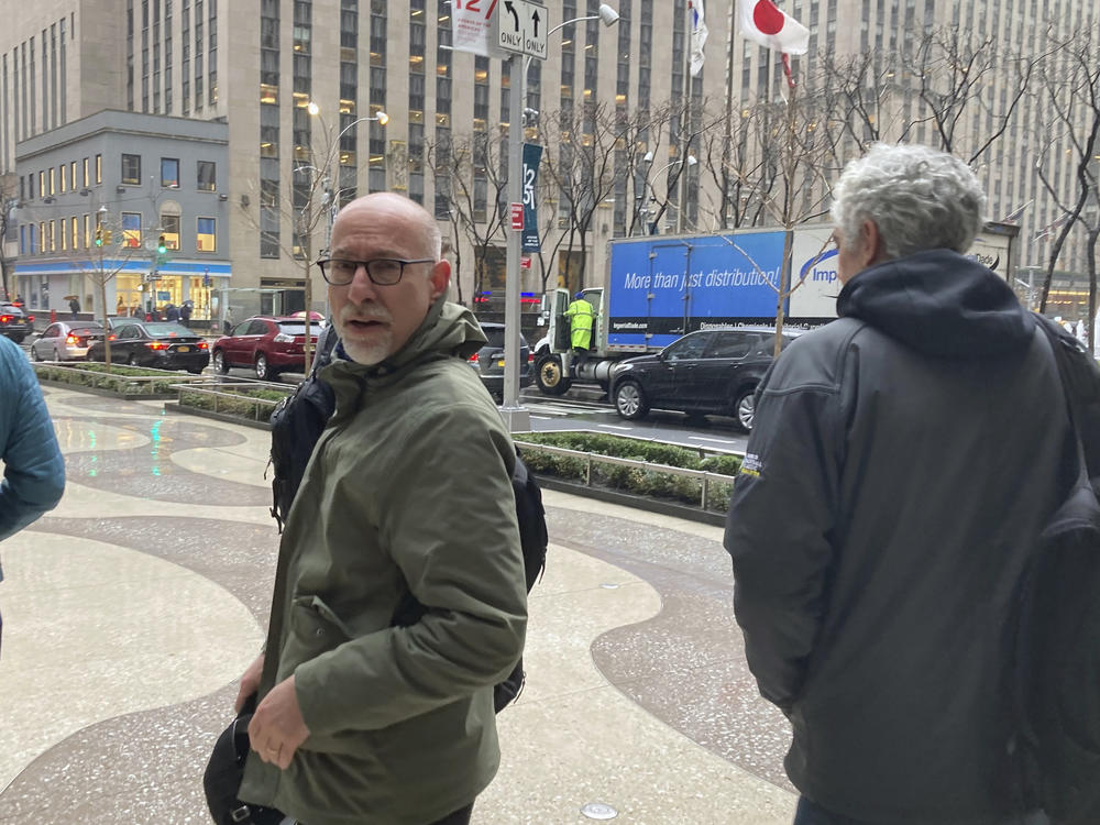 Chief union negotiator Bruce Meyer, center, and general counsel Ian Penny, right, leave Major League Baseball's office in New York, Wednesday, March 9, 2022. Negotiators for locked-out players made their latest counteroffer to Major League Baseball on Wednesday.