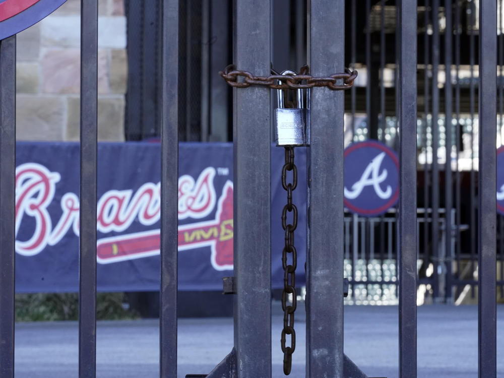 Locked gates are shown at Truist Park home of the Atlanta Braves baseball team Wednesday, March 2, 2022, in Atlanta. Negotiators for locked-out players made their latest counteroffer to Major League Baseball on Wednesday.