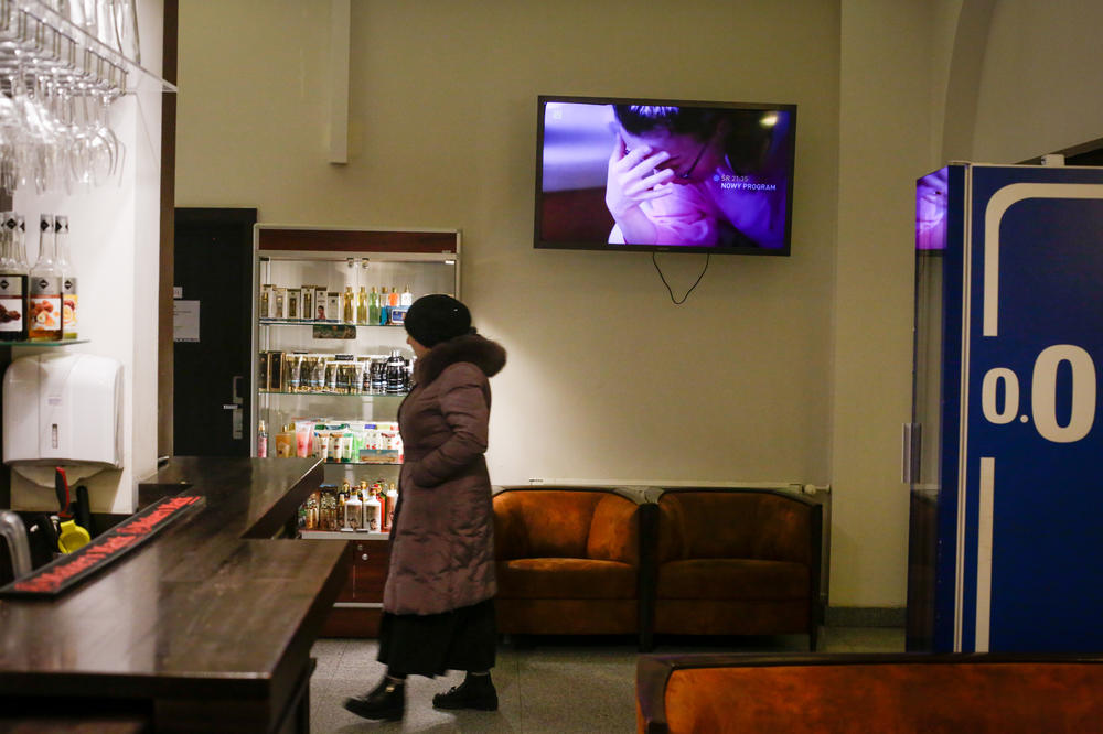 A refugee, recently arrived from Ukraine, walks the halls of the hotel.