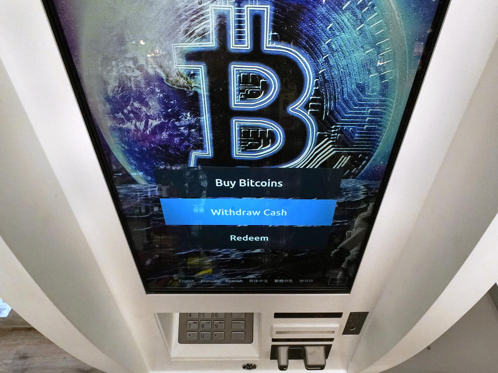 Bitcoin logo appears on the display screen of a cryptocurrency ATM at the Smoker's Choice store in Salem, N.H. (AP Photo/Charles Krupa, File)