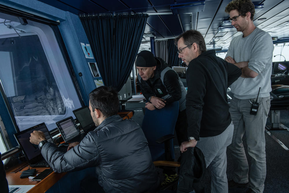 Marc De Vos (from left), senior meteorologist/oceanographer, shows weather data to Jean-Christophe Caillens, off-shore manager; Nico Vincent, expedition subsea manager; and Lasse Rabenstein, chief scientist, on the bridge of the S.A. Agulhas II, seen here last month during the Endurance22 expedition. The expedition team worked from the South African polar research and logistics vessel.