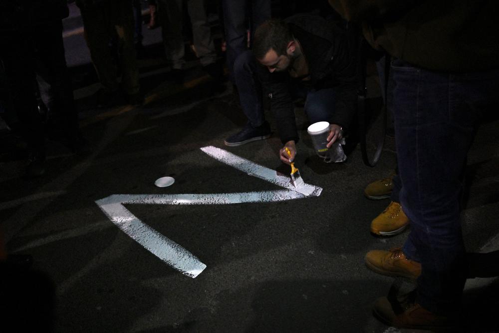 A protester paints the 