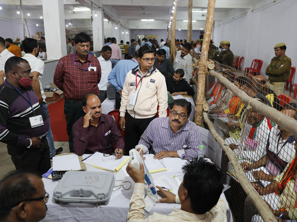 Election officials count votes after Uttar Pradesh state elections in Lucknow, India on Thursday.