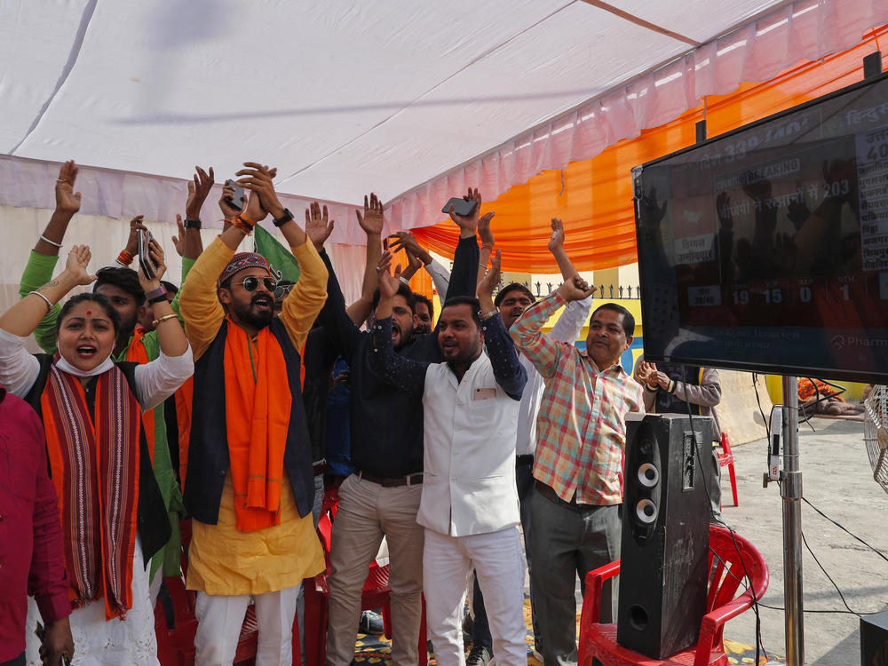 Bharatiya Janata Party (BJP) workers celebrate early leads for the party as election officials count votes after Uttar Pradesh state elections in Lucknow, India, Thursday.