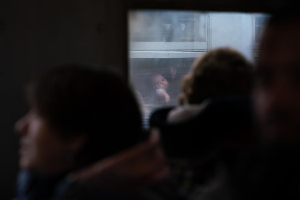 A train from Poland, front, passes a train full of Ukrainian refugees. Most of the millions of displaced people are women and children.