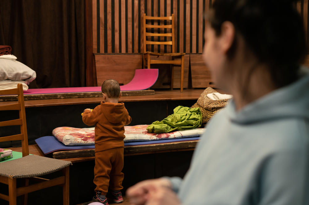 Maksim plays with toys at the church where the family slept after leaving Kyiv. They were able to find food and supplies — including diapers for him — in the donations at the church.