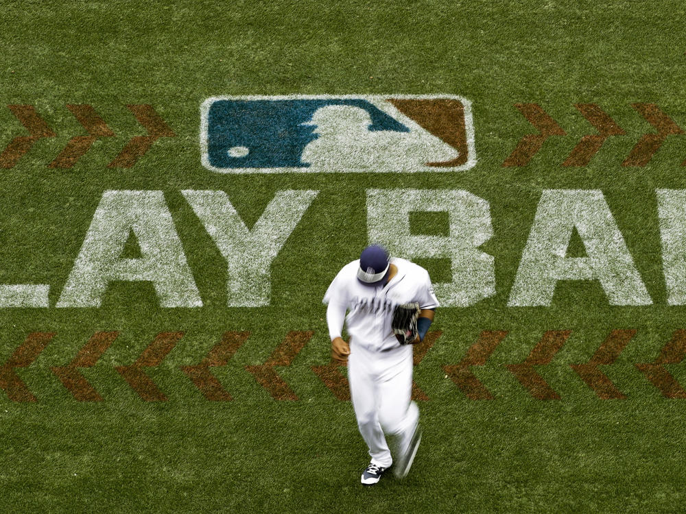 San Diego Padres left fielder Allen Cordoba passes a logo for Play Ball, an initiative from Major League Baseball and USA Baseball, during the fifth inning of a baseball game against the Colorado Rockies in 2017 in San Diego. Players voted Thursday to accept MLB's offer on new labor deal, paving way to end 99-day lockout and salvage 162-game season.