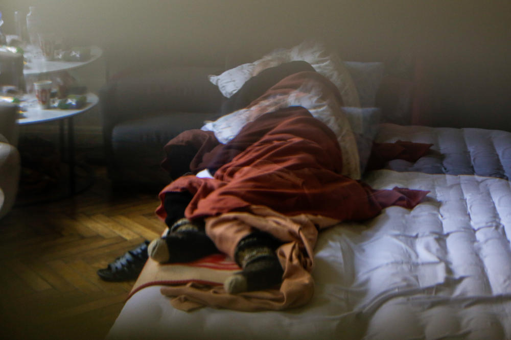 A man sleeps in a cafe-turned-shelter in Lviv, Ukraine. The western city is now a main transit point for refugees coming from all over the east, housing hundreds of thousands of displaced Ukrainians.