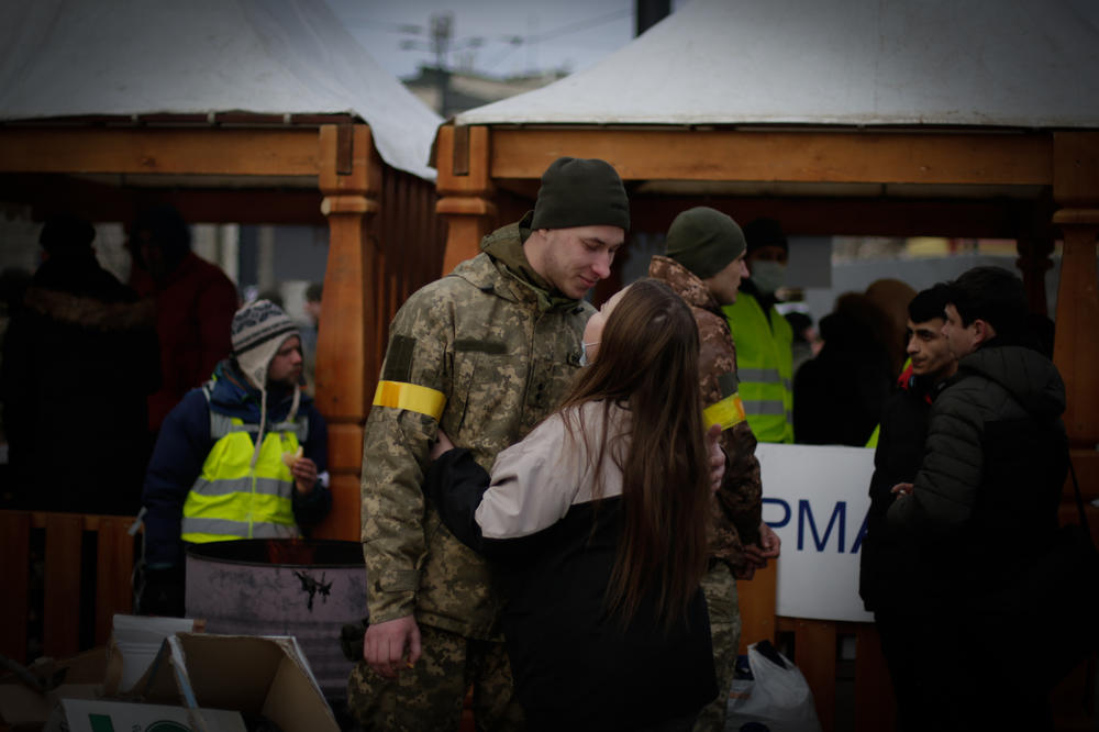 A soldier says goodbye to his wife at the train station in Lviv.