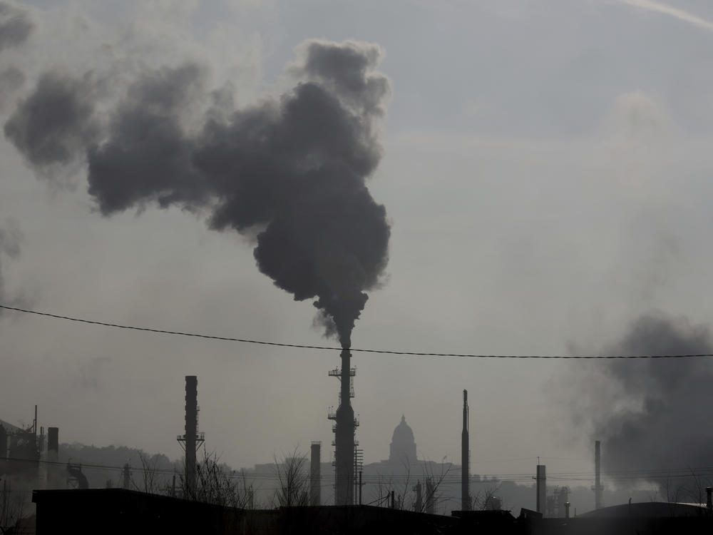 Smokestacks near an oil refinery are seen in front of the Utah State Capitol as an inversion settles over Salt Lake City in 2018. The air we breathe kills thousands of Americans every year.