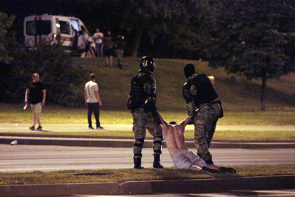 Riot police detain a protester after polls closed in the presidential election, in Minsk in Aug. 2020.
