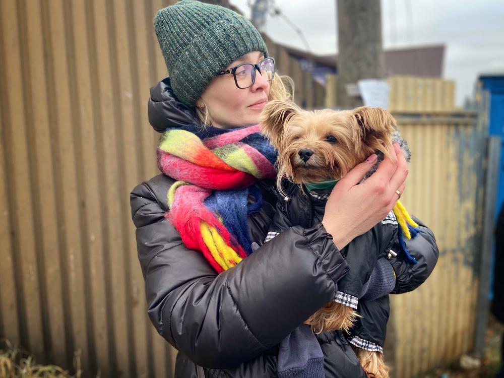 Evgenia holding her dog Kienia at Medyk border crossing in southeast Poland.